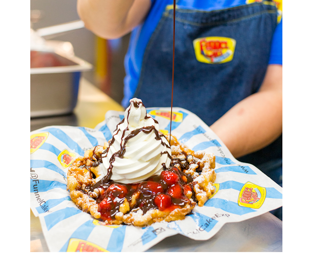 Bullet Funnel Cake topped with vanilla soft serve, strawberry fruit toppings and chocolate sauce