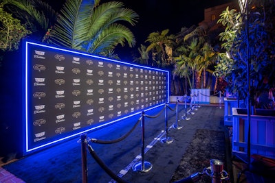 The event had a blue neon-outlined step and repeat, plus lighting by Images by Lighting, scenic from Whalefilm, and audio from On Stage.