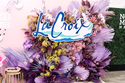 LaCroix handed out its popular bubbly beverage at its pop-up space, along with colorful, branded swag. Large, lavender-colored palm fronds matched the florals on the conference’s main stage.