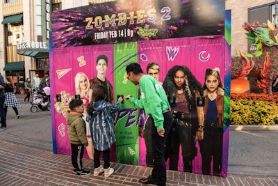 To promote the Disney Channel's new Zombies 2 film, the company worked with GDX Studios on a family-friendly stunt that placed lockers at various locations around the country. Passersby of all ages were encouraged to open the lockers, where zombie, werewolf, or cheerleader hands would give them a themed prize. In addition to the Grove in Los Angeles (pictured), the stunt traveled to San Diego; Raleigh, North Carolina; Louisville, Kentucky; Baltimore; Philadelphia; Orlando; and Miami; in all, some 10,000 gifts were distributed.
