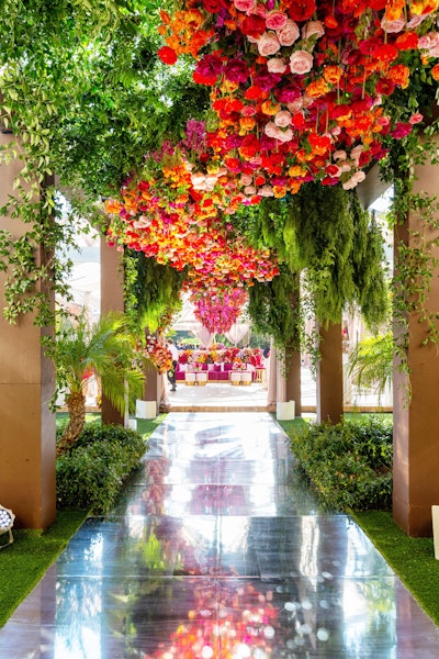 At entertainment agency Roc Nation’s annual Grammys brunch, So Events designed a living garden ceiling hanging above a mirrored walkway. The gathering had a colorful palette featuring bold burgundies and subtle blushes inspired by Spain.