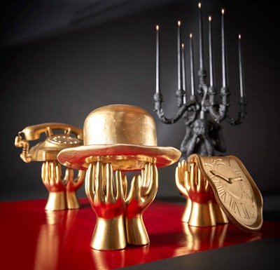 Instead of traditional table numbers, Friedland created Dalí-inspired symbols—such as a melted clock—that directed guests where to sit. The props were worked into the centerpieces along the dinner tables.
