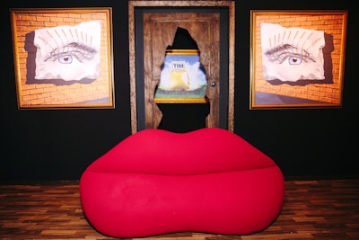 A photo booth was inspired by Dalí’s Mae West Lips Sofa, a sculpture the artist created in 1937. On the walls were paintings of the guest of honor’s eyes with cigar eyelashes. The photos were framed in the same style as the invitation.