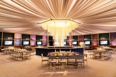 Warner Bros. and InStyle magazine's annual post-Golden Globes party, produced by JOWY Productions, used dramatic draping and a palette of rich blues, golds, cream, and white to complement a central gold-tiered Deco-style chandelier.