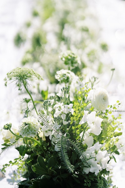 A stretch of white and green blooms decorated the length of the otherwise spare table.