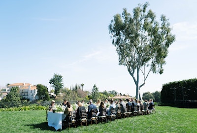 The luncheon was set at a single banquet table on the property’s expansive lawn.