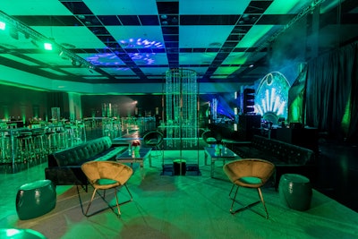 Blueprint Studios transformed California's Santa Clara Convention Center into The Wizard of Oz's Emerald City with lighting by Gatsby Entertainment Group and themed florals from Flowers by Edgar. Blueprint Studios also tapped their own emerald-colored furnishings in the form of tufted couches, velvet lounge chairs and barstools, illuminated dining tables, and more.