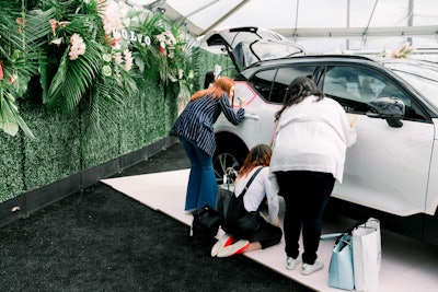 Attendees were able to write their intentions on a vehicle at the Volvo activation, which featured greenery-lined walls and tropical arrangements.