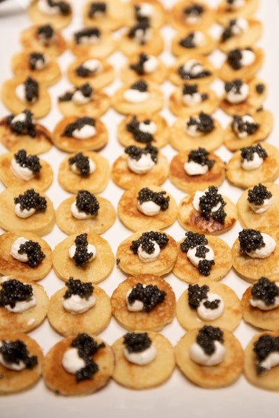 Guests nibbled on upscale cocktail party fare, including deviled quail eggs, smoked salmon on pumpernickel with caper cream cheese and lemon zest, and blinis with crème fraiche and black caviar.