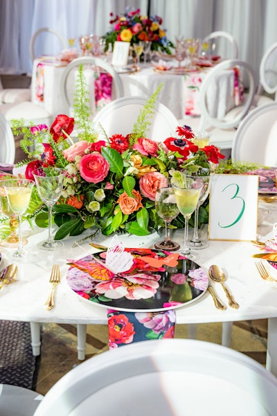 Floral chargers from Nuage Designs echoed the tablescape's florals. In addition, Saima Says Design created a springtime-inspired, butterfly-shaped menu card.