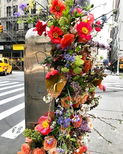 Lewis Miller Design used florals from a canceled event to decorate a phone booth in New York.