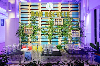 Another wall of wooden pallets was located behind the bar, with green moss used to spell the name of the event and shelves holding Absolut bottles.