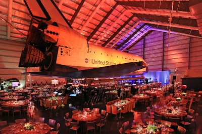 'Inside the pavilion, guests were treated to an elegant, ethereal, and even a bit understated and humble dining environment under the space shuttle Endeavour, as they were asked to imagine themselves as the honored guests at the first dinner party on Mars,' said Sion. The dinner space featured a color palette of burnt terra-cotta and cerulean blue, which was lit by Images by Lighting to evoke the colors of the Martian landscape.