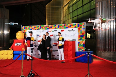 Upon entering the 650-person black-tie Discovery Ball, guests passed through a fun step-and-repeat that introduced the evening's LEGO theme, and had their pictures taken by 'drone paparazzi' from Foto Spark. As in previous years, the decor was intended to evoke the museum's new exhibit; this year was The Art of the Brick, which sees artist Nathan Sawaya creating and reinterpreting classic art—using LEGO as his medium. The exhibit was made using more than one million LEGO bricks and 100 sculptures, and Sawaya loaned an additional 12 pieces from his collection to serve as decor for the March 7 fundraiser.