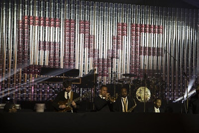 For the small stage backdrop, 1,200 paint cans were arranged to spell out the word 'give.' See more: Why Brad Pitt's New Orleans Gala Had a Construction Theme