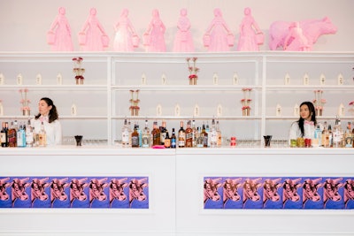 Keeping the mix of art and LEGO going was a 'milk bar' using wallpaper from Andy Warhol's pop-art cow series. Edge Design & Decor created custom diving panels and cocktail table toppers that tied into Sawaya's pink 'Eight Maids-a-Milking' sculptures, which served as a focal point for the 32-foot bar. Sion called the sleek setting 'another example of how we infused and played with the world's most recognized artists along with LEGO bricks.'