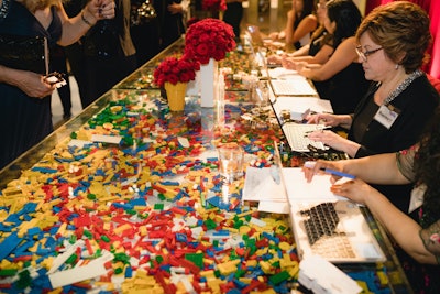 The 90-minute cocktail reception, which took over three floors of the museum's main building, immediately evoked the exhibit with a registration table filled with colorful bricks. Other on-theme highlights included an evening gown fabricated entirely from LEGO bricks, which Sawaya had created for Her Universe's Ashley Eckstein to wear at Comic-Con. The eye-catching dress was displayed on a mannequin at the entrance to the party and helped draw attention to the evening's raffle: a 2020 Lexus UX 250h Hybrid donated by Toyota Motor North America, Inc.