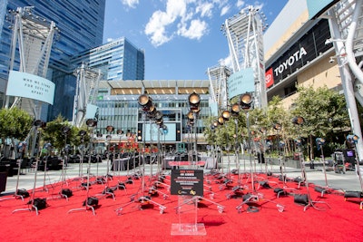 An empty red carpet set, which served as the setting for the day's speeches, included a lighting installation with 48 fixtures, each representing 250,000 industry professionals. The idea was 'to pay homage to all our empty carpets within the entertainment industry—film, TV, theater and events—and beyond that, be an ode to Hollywood. Los Angeles is filled with so many artistic installations in the form of expression and this was ours, inspired by Chris Burden’s iconic ‘Urban Light' sculpture,' said Rembac.