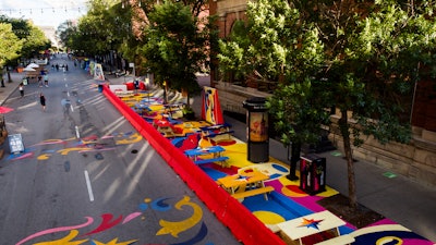 'Together Apart Street Art' is a large-scale outdoor art installation on Saint-Laurent Boulevard. The 140-foot-long mural uses shapes, lines, and vibrant contrasting colors to direct pedestrian flow and encourage social distancing.
