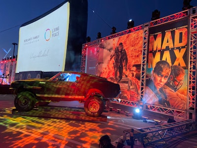 The July 31 fundraiser, which benefited the Charlize Theron Africa Outreach Project, drew roughly 90 cars for a live stunt show, Q&A, silent auction, and screening of Mad Max: Fury Road.