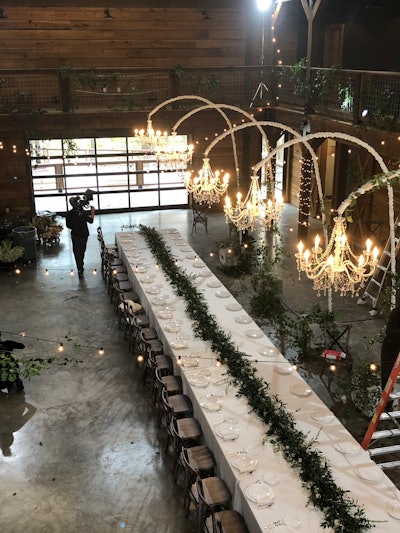 This fairy tale-inspired wedding included a long dining table with suspended chandeliers.