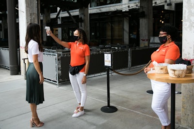 Guests' temperatures were taken prior to entry as one of the event's safety protocols. Although masks were not required in the tented terrace space, they were encouraged in the elevator. If guests arrived without one, a complimentary branded and reuseable Juice Studios mask was available to them.