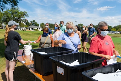 A color-coded wristband system allows the production company to keep track of each group.