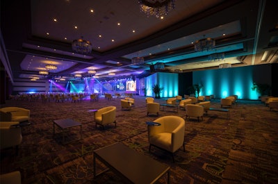A separate seating area used during breaks featured barrel chairs with built-in company-branded tables, allowing for attendees to break off from the bigger group and socialize safely in a smaller setting.