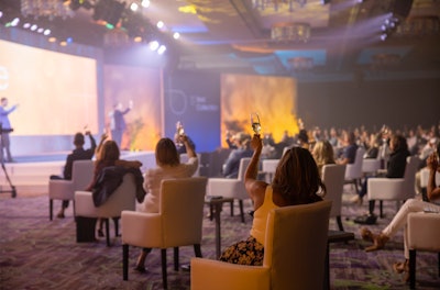 The venue's banquet staff, wearing gloves and masks, delivered glasses of Champagne to each attendee for the entire team to toast the company's future from six feet apart.