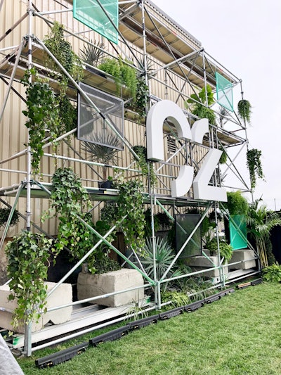 The venue’s outdoor space, the C2 Village, is where guests checked in and out. The space featured a massive welcome wall with the conference logo, surrounded by industrial elements and greenery.