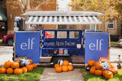 The e.l.f. Cosmetics Spooktacular Halloween Truck was outfitted with plenty of sparkle and Halloween-inspired decor, including branded pumpkins, a neon light wall for photo ops, and a product display with e.l.f. products.