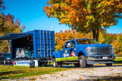 The large, 20-foot shipping container will make 13 stops during football season.