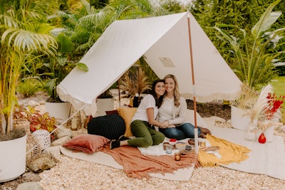 One of five pop-ups took glamping to the next level with a canvas teepee surrounded by cushions, woven lanterns, and unique greenery.