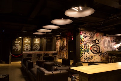 This week saw the opening of Live Axe, a 10,000-square-foot activity venue in Manhattan's SoHo neighborhood. Billed as an 'elevated axe-throwing destination,' the space has an industrial chic-meets-pop art vibe, with seven cage-enclosed axe-throwing lanes, a black-iron bar with futuristic tube lighting, and custom murals of celebrities reimagined as vikings. A private event room has its own bar and three additional throwing lanes. Live Axe also has a full food menu and roster of creative cocktails—making it the only venue of its kind in New York with a full liquor license.