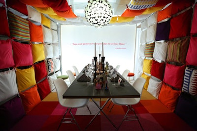 Inspired by textile artist Alexander Girard and a child's bedroom, Herman Miller's table designed by IA Chicago was surrounded with colorful pillows. After the event, the pillows were donated to The Boys & Girls Club. See more: 25 Tabletop and Decor Ideas From Diffa's Dining by Design in Chicago