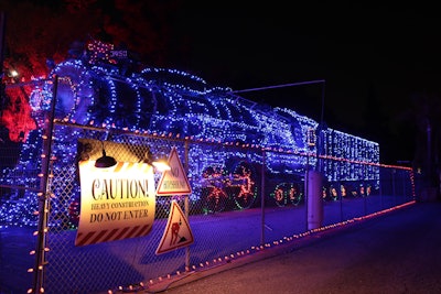 The multisensory drive-thru takes guests through an hourlong theatrical adventure, where they attempt to save Christmas after Santa experiences a sleigh mishap. A series of larger-than-life sets included a toy repair workshop, a gingerbread village, an Arctic winter wonderland, and more.