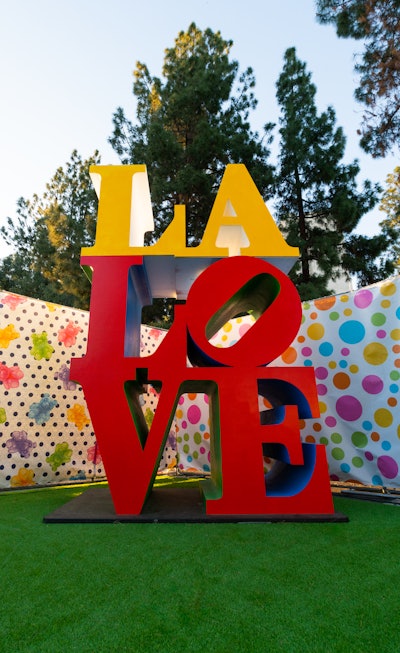 At the end of the experience, guests are swirled back to reality and sent off with a full bag of candy to satisfy their sweet tooth, and then they are invited to stroll in Gumdrop Park. The expansive, 25,000-square-foot grassy playground has picnic tables, swings and more micro-installations such as this 'LA LOVE' sign.