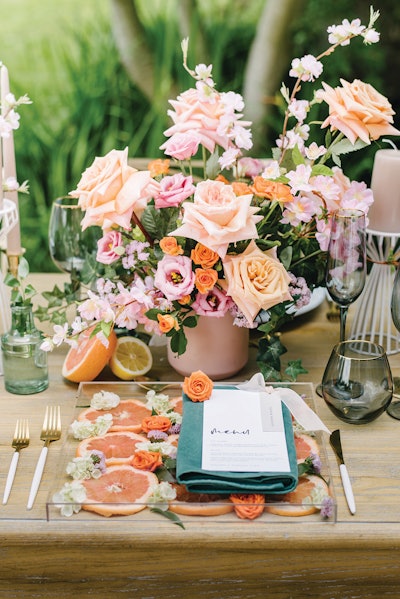 When asked for a decorative place setting to complement a summer soiree, Toronto-based event rental company Table Tales answered with fruity accents and velvet napkins atop acrylic box charger plates.