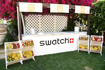 Another Coachella 2019 event, the Zoe Report's annual ZOEasis, had a fruit-filled display from sponsor Swatch. The activation was inspired by a fruit cart, with Swatch watches displayed atop piles of colorful fruit.