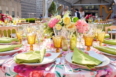 Round tables were adorned with floral print and fresh lime green linens, along with springtime arrangements featuring blooms in pink and yellow hues.