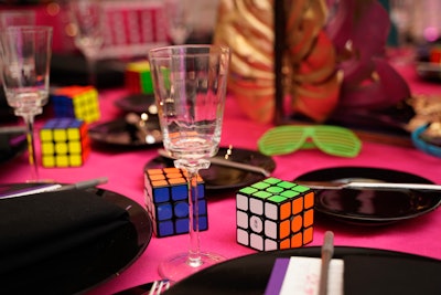 Rubik’s cubes, fishnet gloves and more decade-related trinkets served as table decor.