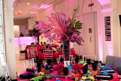 Bright-pink table linens and giant palm fronds played into the '80s theme.