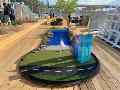 At developer Two Trees' climate change-themed golf course, hole #8 was designed by the Williamsburg High School for Architecture and Design. Called “Surge Garden,” the installation explains how strategies for coastal residency—like living breakwaters, coasting plantings and riprap shorelines—can protect urban shorelines from storm surges and sea level rise.