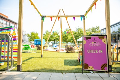 The daytime event featured a camp theme with outdoor seating and pops of color.