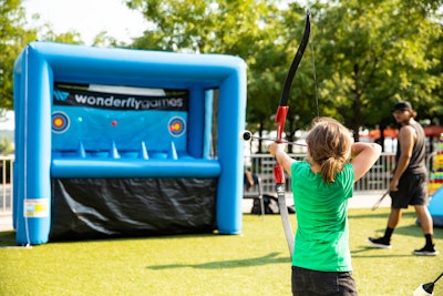 Attendees took aim at an inflatable archery game provided by Wonderfly Games.