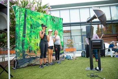 Attendees posed in front of the event's nature-inspired backdrop.