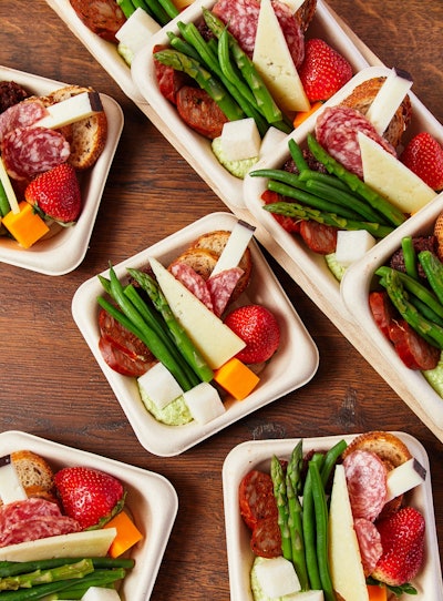 Individual charcuterie plates with chicken chorizo, fennel sausage, manchego, drunken goat cheese, crudite, fruit and crostini, from Constellation Culinary Group in California, Florida, the Mid-Atlantic region, New England and Washington, D.C.