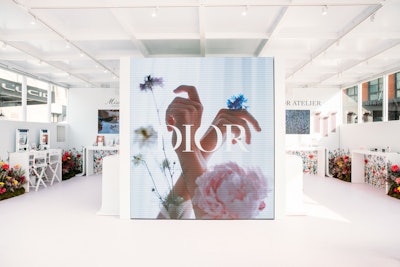 The highly stylized interior featured a floor-to-ceiling video wall, makeup and perfume experiences, and custom bouquet-making.