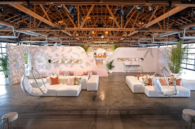 The venue’s main space was divided via pink intersecting walls, which kept attendees from entering the panel discussion area too early—and encouraged them to mingle, take selfies and relax in a variety of seating options including hanging bubble chairs. 'Gymshark events are all creating community and people coming together,” said producer Matt Stoelt.