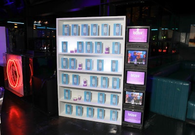 Display shelves adorned with branded VHS tapes were flanked by TVs playing old-school videos.
